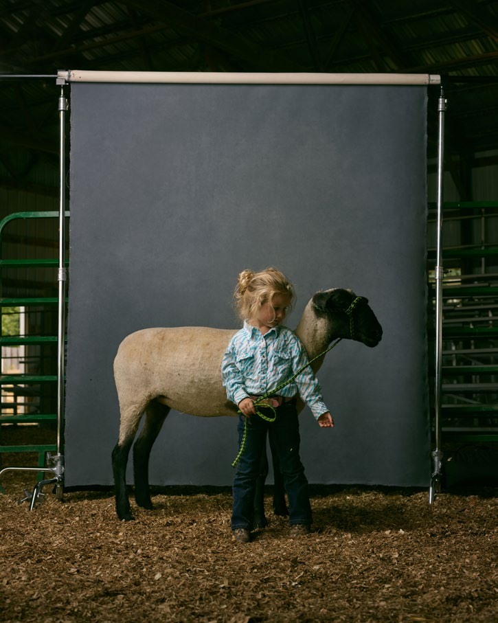 R. J. Kern Child poses with sheep.